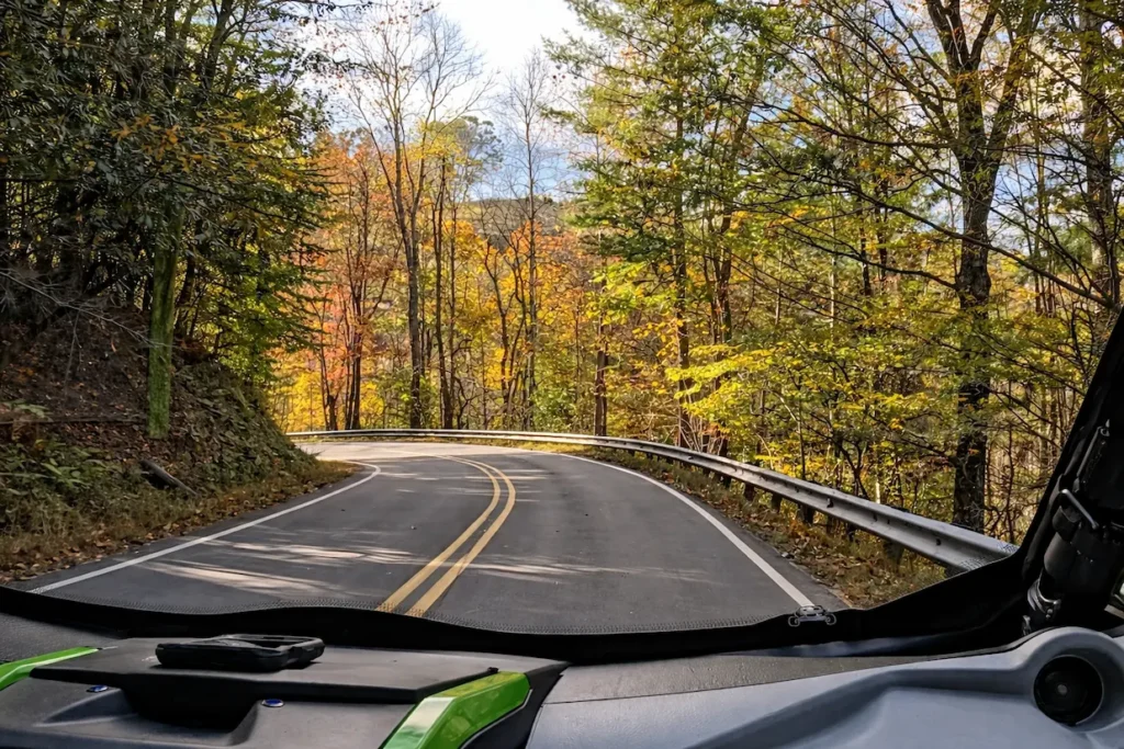 Point of view from inside a UTV rental driving through fall foliage in the Smoky Mountains